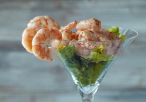Shrimp Cocktail In A Martini Glass, Garnished With Atlantist Two Rocks.