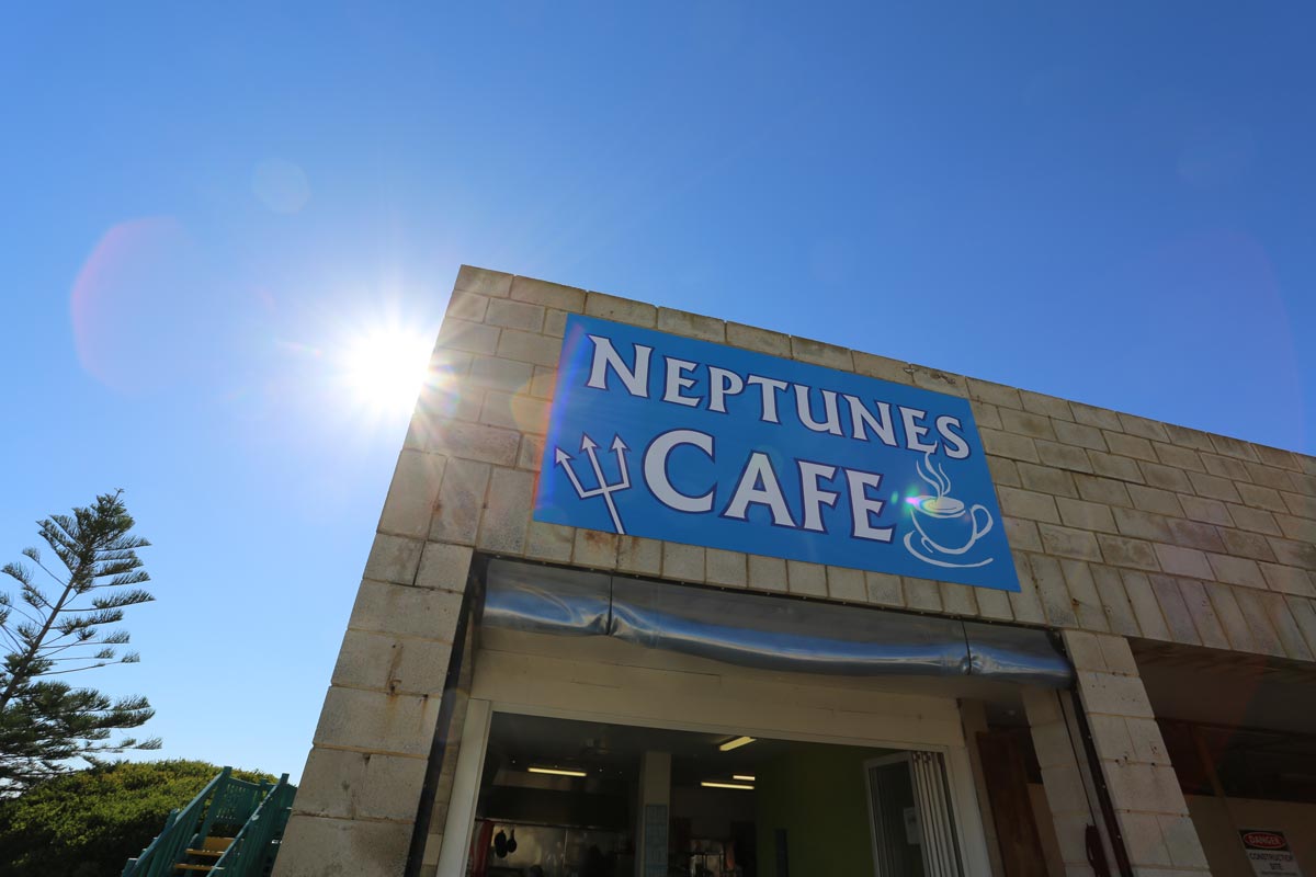 Neptune's Cafe at Atlantis Beach: A building with a sign, offering a delightful dining experience.