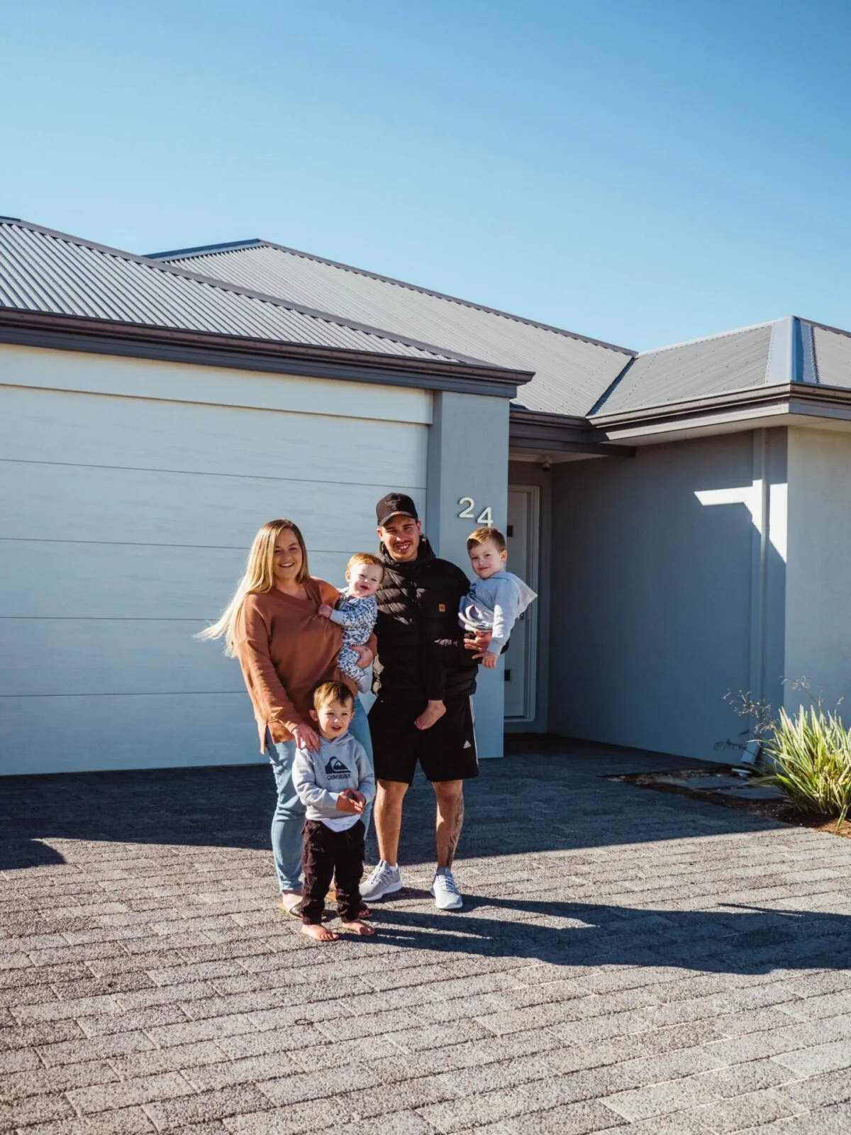 Leteesha And Her Family Outside Their New Home In Atlantis, Two Rocks